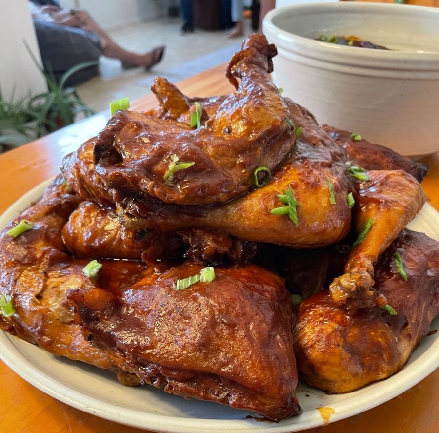 Platter of BBQ-glazed chicken garnished with green onions