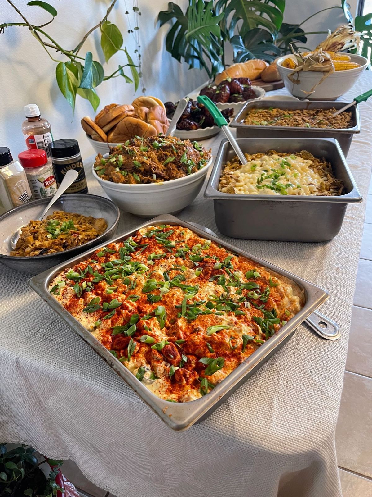Hot buffet line in chafing trays with enchilada casserole and sides