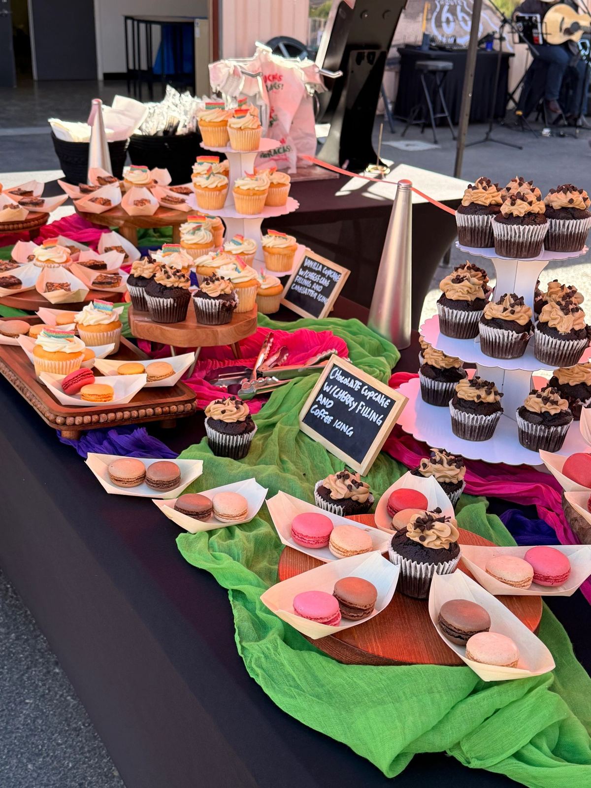 Dessert display with cupcake towers and macarons on a styled table