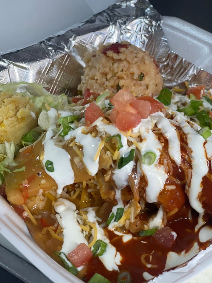 Dinner plate smothered in red chile with rice and sweet corn pudding