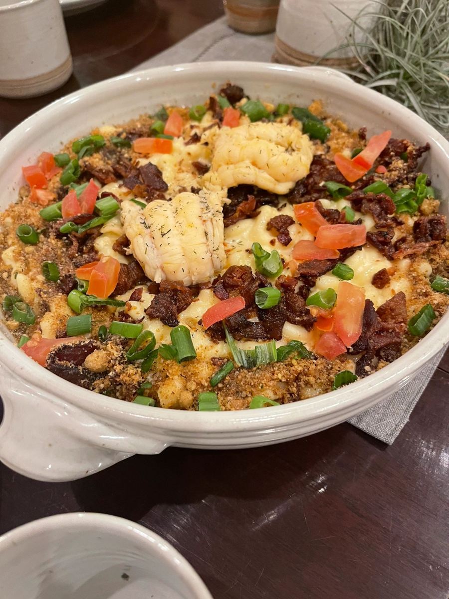Lobster mac and cheese special topped with bacon, tomatoes and green onions
