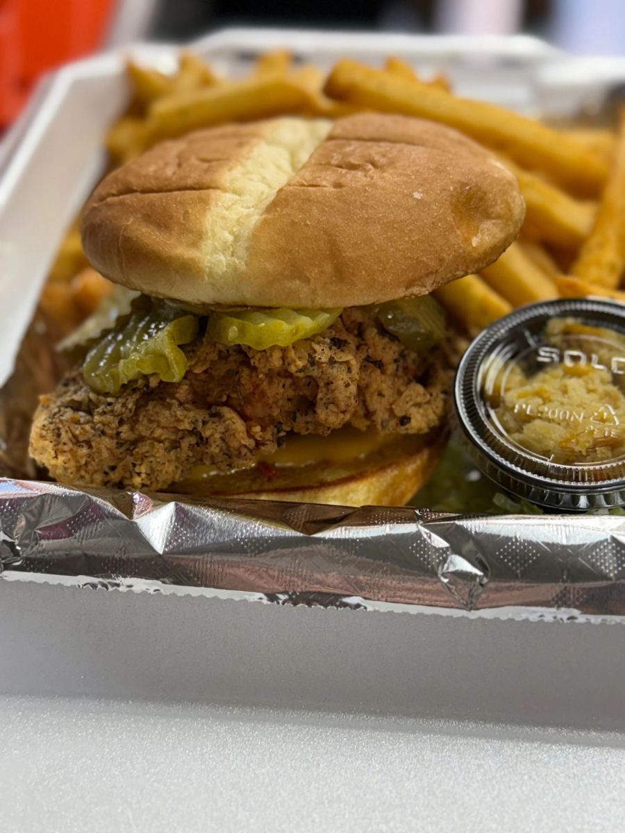 Crispy chicken sandwich with pickles and fries