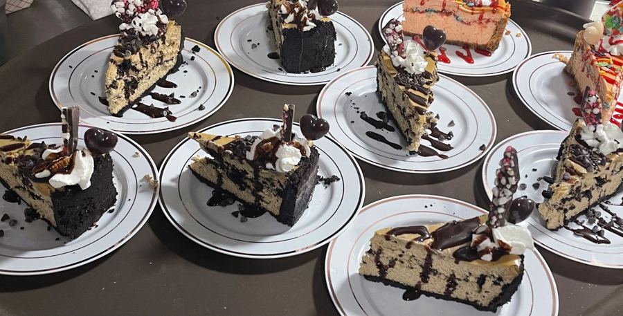 Slices of layered cheesecakes and cakes plated with chocolate drizzle